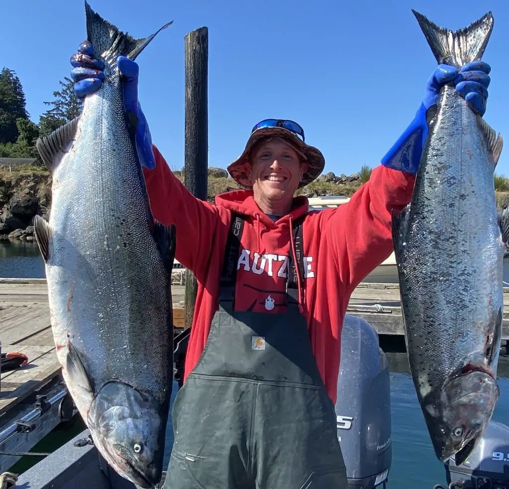 Holding two nice downrigger caught king salmon