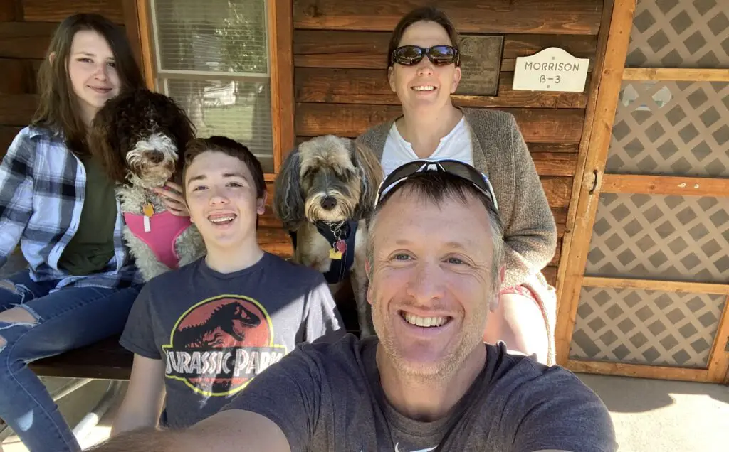 Family selfie in front of morrison cabin in lewis and clark caverns state park