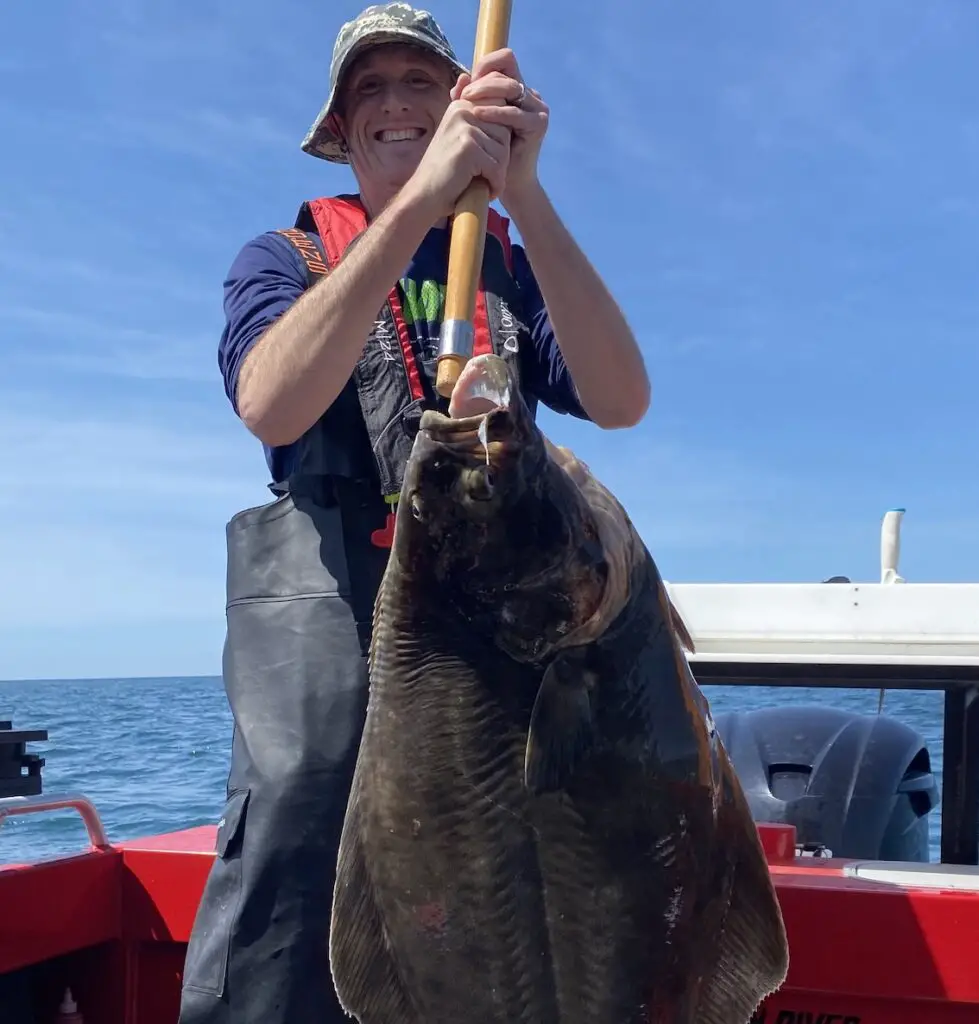 Me holding 47 lb halibut up with Gaff