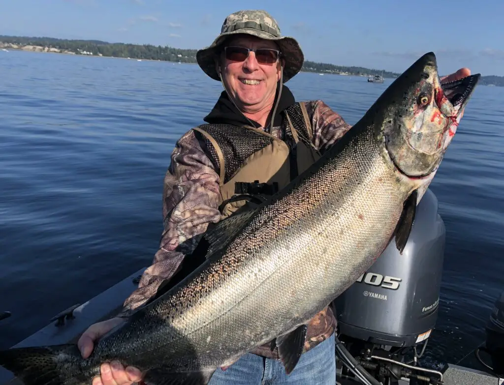 Ash holds king chinook from marine area 10